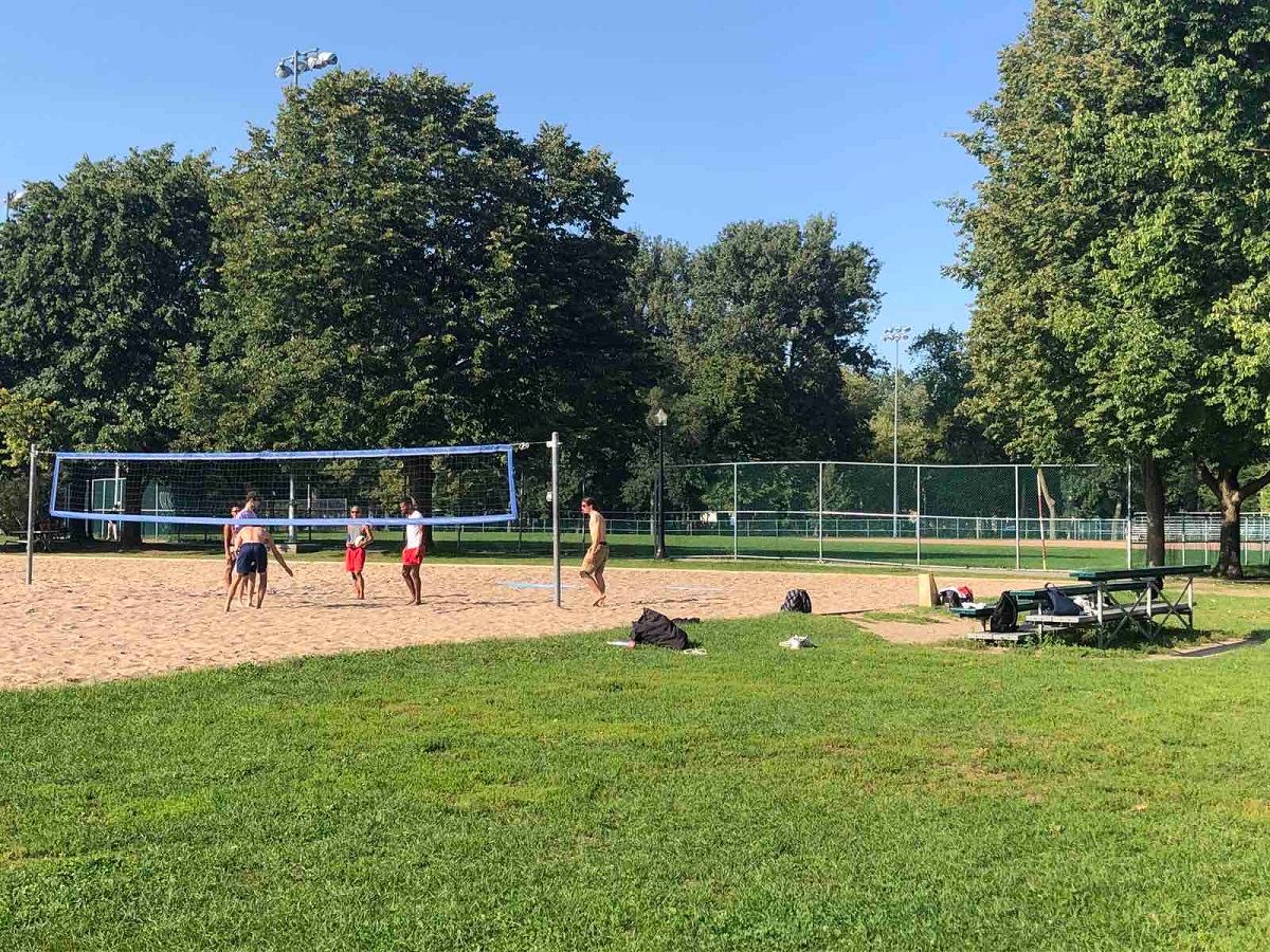 People playing volleyball in a park