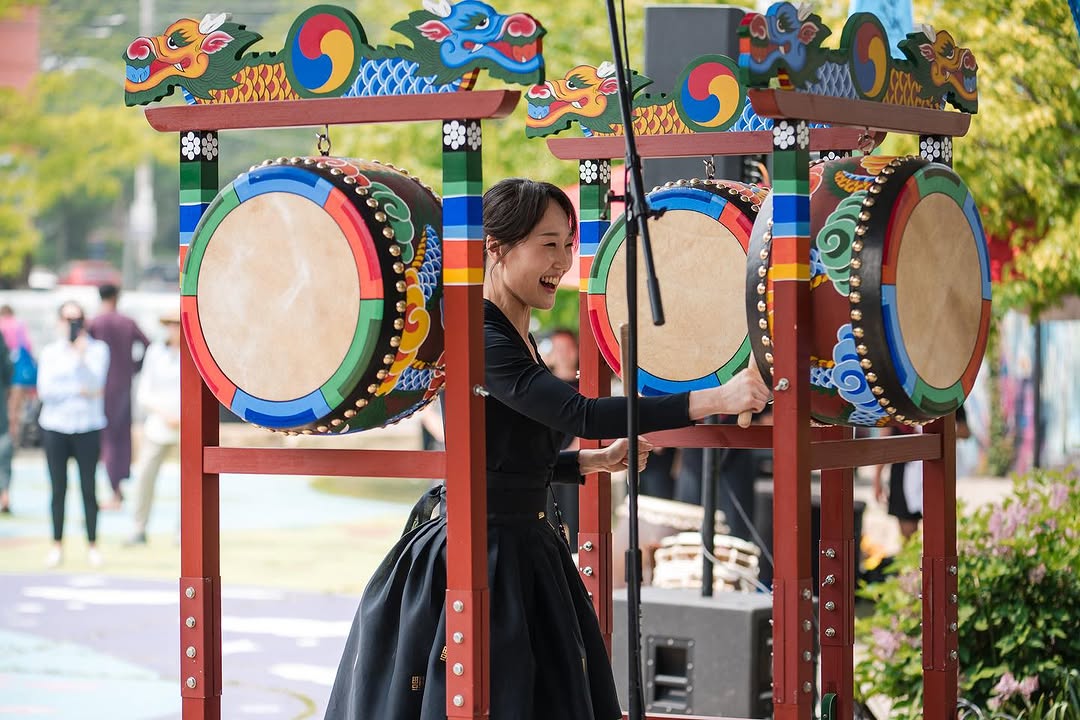 A asian woman drumming