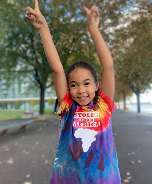 A young black girl with a t-short "stolen from Africa"